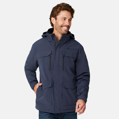 [Model is wearing size M.] A man wearing a navy blue hooded jacket with black zippers and pockets, standing against a light gray studio background.