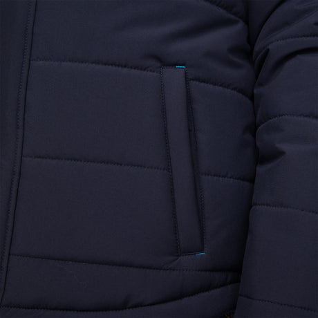 Close-up of Free Country's Boys' Trail Puffer Hoodie Shacket in dark blue, showing a rectangular side pocket with subtle stitching and a touch of blue along the pocket’s edge.