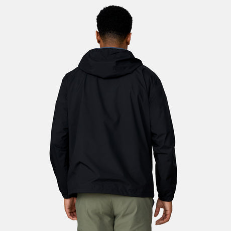 [Josiah is 6'3" wearing a size Medium.] Man wearing the Free Country Men's Agile II Windshear Jacket in Black, size M, made from lightweight wind and water resistant recycled polyester fabric and featuring an attached hood, inner phone pocket and elastic cuffs, styled with a black t shirt and black pants #color_ black