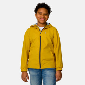 A smiling child wears the Clearance Boys' Easy Hiking Windshear Jacket in yellow over a white shirt and blue jeans, standing against a plain light gray background.