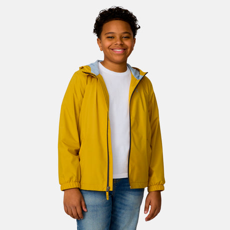 [Model is wearing a size Medium.] Boy wearing the Free Country Boys' Easy Hiking Windshear Jacket in Gold, size M, featuring a full length zipper, paired with  blue jeans #color_ gold