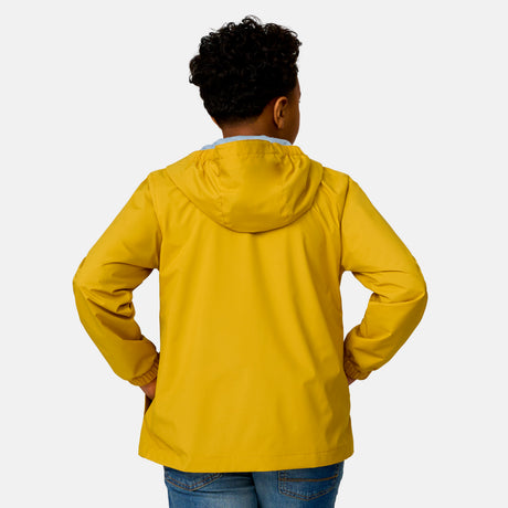 [Model is wearing a size Medium.] Boy wearing the Free Country Boys' Easy Hiking Windshear Jacket in Gold, size M, featuring lightweight wind and water resistant fabric and an attached hood, paired with  blue jeans #color_ gold