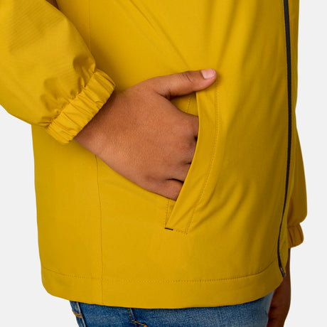 [Model is wearing a size Medium.] Boy wearing the Free Country Boys' Easy Hiking Windshear Jacket in Gold, size M, featuring lower pockets, paired with  blue jeans #color_ gold
