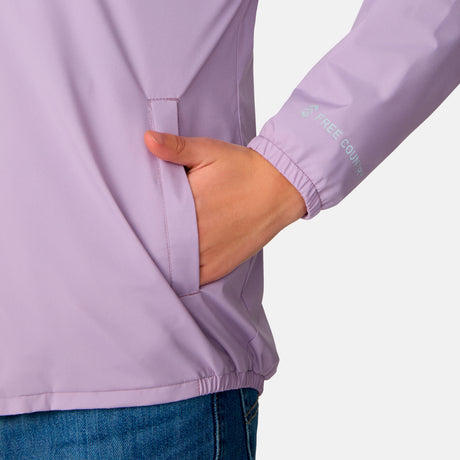 A person wears the Clearance Girls' High Stretch Windshear Jacket in light purple with blue jeans, right hand in the jacket pocket. Only their torso and arm show against a plain light background.