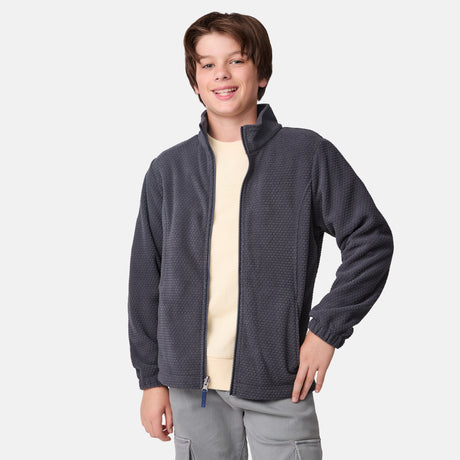 [River is wearing size M] Model in a two-tone Free Country system jacket featuring a dark gray upper shell and lighter gray lower body; complete with zip-out fleece liner, side-entry pockets, and an adjustable hood—styled with tonal gray pants for streamlined, cold-weather versatility.