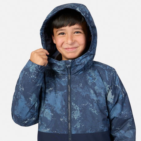 A boy wearing a blue Boys’ High Stretch 3-in-1 Systems Jacket with a hood and a subtle geometric pattern.