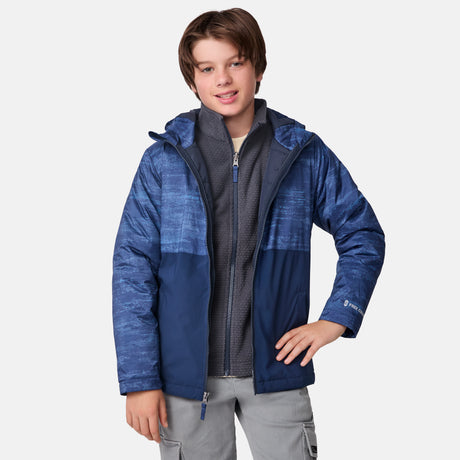 [River is wearing size M]Model in a two-tone blue Free Country 3-in-1 system jacket featuring zip-out fleece lining, rugged shoulder textures, and a smooth shell exterior; styled with a light base layer for adaptable, cold-weather comfort.