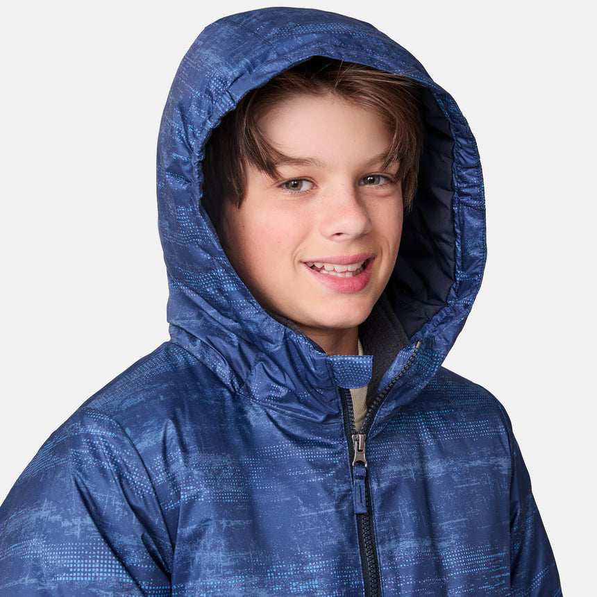 [River is wearing size M]Model in a two-tone blue Free Country 3-in-1 system jacket featuring zip-out fleece lining, rugged shoulder textures, and a smooth shell exterior; styled with a light base layer for adaptable, cold-weather comfort.