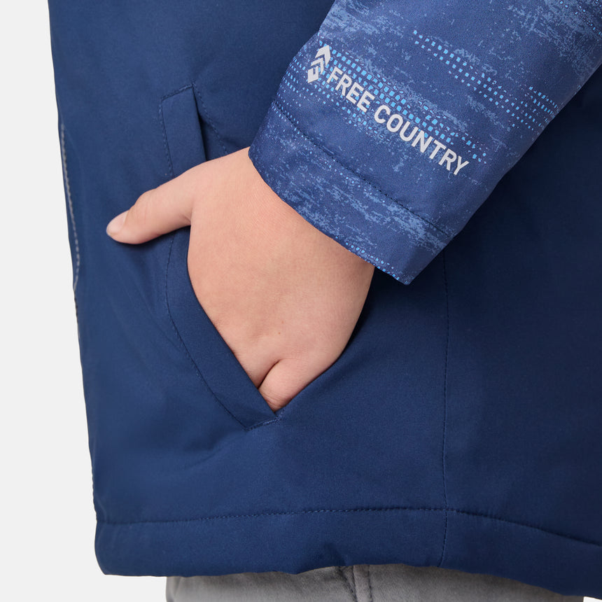 [River is wearing size M]Model in a two-tone blue Free Country 3-in-1 system jacket featuring zip-out fleece lining, rugged shoulder textures, and a smooth shell exterior; styled with a light base layer for adaptable, cold-weather comfort.