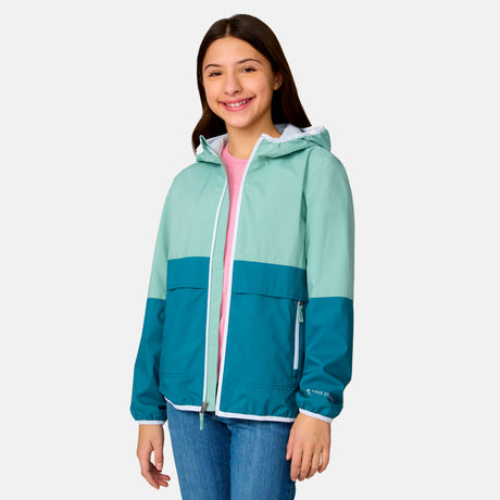 [Model is wearing a size Medium.] Girl wearing the Free Country Girls' Easy Hiking Windshear Jacket in Green Tea, size M, featuring two tones color made from recycled polyester fabric that provides four way stretch and water and wind resistance, layered over a pink t shirt with blue jeans #color_ Green-Tea