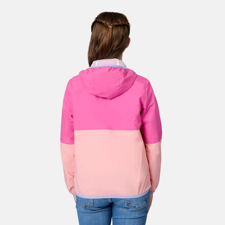 A girl with brown hair in a braid is shown from behind, wearing the Free Country Girls' Easy Hiking Windshear Jacket in pink and light pink, paired with blue jeans against a plain light background.