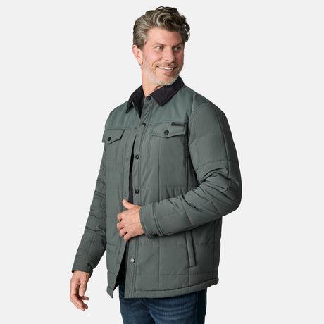 [Kolby is 6'2" wearing size M.] Men’s Free Country green quilted jacket with black corduroy-style collar and button-up front—featuring dual flap chest pockets, angled side hand pockets, and a rugged outdoor look. Paired with dark pants for versatile, cold-weather styling.