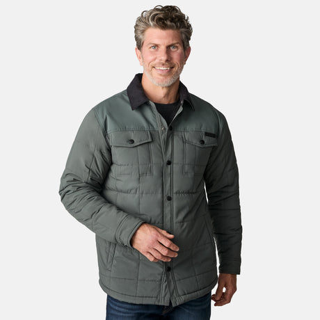 [Kolby is 6'2" wearing size M.] Men’s Free Country green quilted jacket with black corduroy-style collar and button-up front—featuring dual flap chest pockets, angled side hand pockets, and a rugged outdoor look. Paired with dark pants for versatile, cold-weather styling.