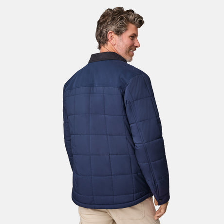 [Kolby is 6'2" wearing size M.] Men’s Free Country dark blue quilted jacket with button-up front, flap chest pockets, and contrasting corduroy-style collar—styled with light-colored pants for a rugged, heritage-inspired outdoor look.