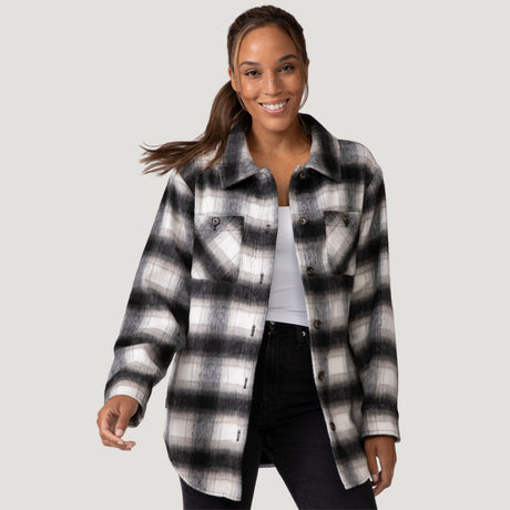 [Shelby is 5'9" wearing a size Small.] Woman wearing Free Country Women's Hayley Plaid Shacket in black and white plaid with a full front button opening, chest pockets, light grey background. Best women’s jacket for fall weather.