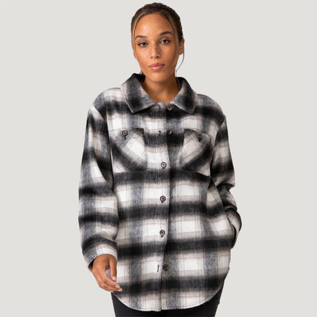 [Shelby is 5'9" wearing a size Small.] Woman wearing Free Country Women's Hayley Plaid Shacket in black and white plaid with a full front button opening, chest pockets, light grey background. Best women’s jacket for fall weather.