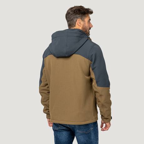 A man faces away from the camera, wearing the Clearance Men's Flat Lands Hurricane Softshell® Jacket in brown and dark gray with blue jeans, set against a plain light gray background.