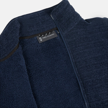 Close up of navy fleece jacket pile lining with Free Country logo on a white background