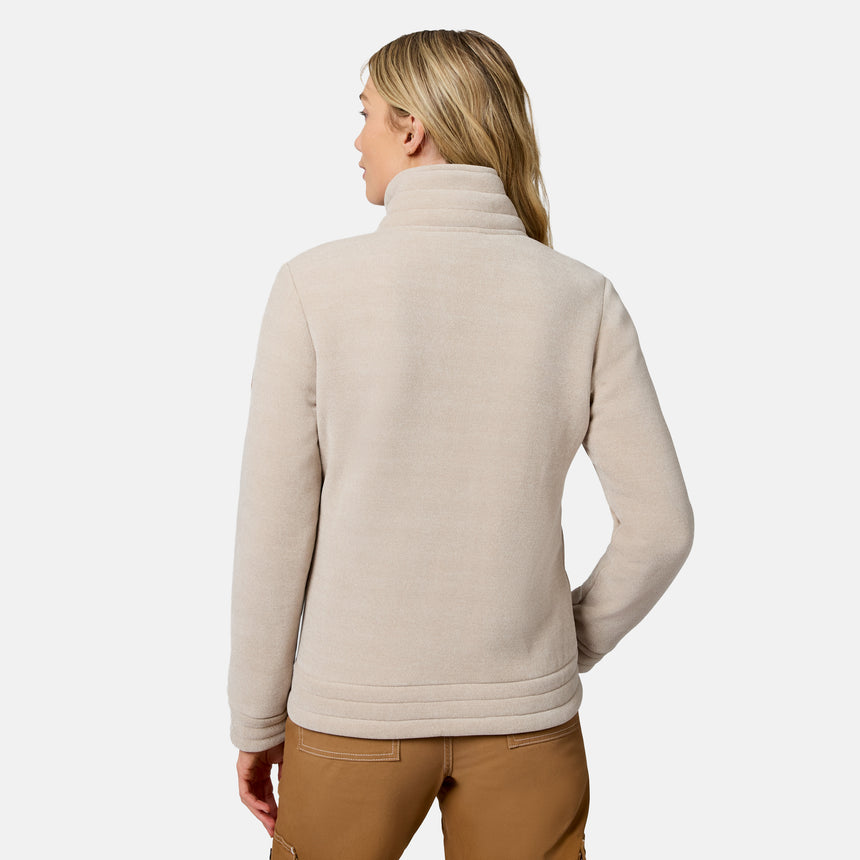 A woman shown from the back wearing a light beige fleece pullover sweater and brown pants against a clean white studio background.