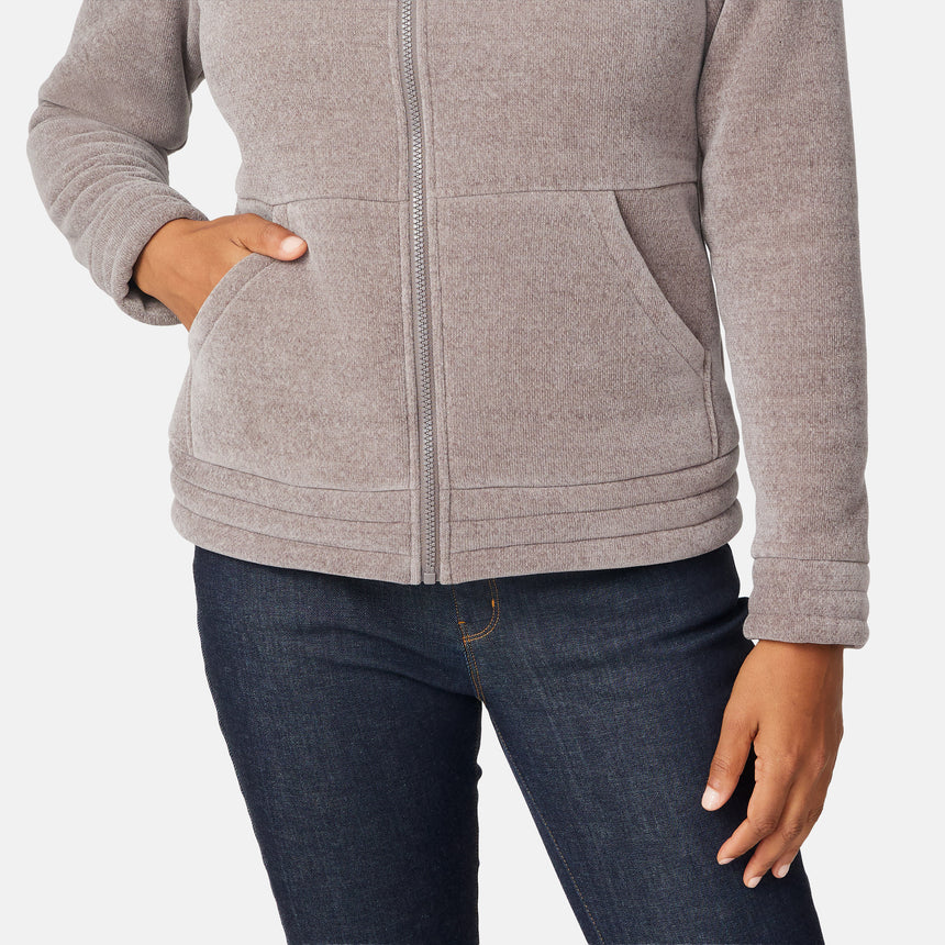 [Angelique is 5'10" wearing size S.] Women’s light brown zip-up jacket with high collar and textured finish, styled with two front pockets and paired with dark blue jeans against a plain white background.
