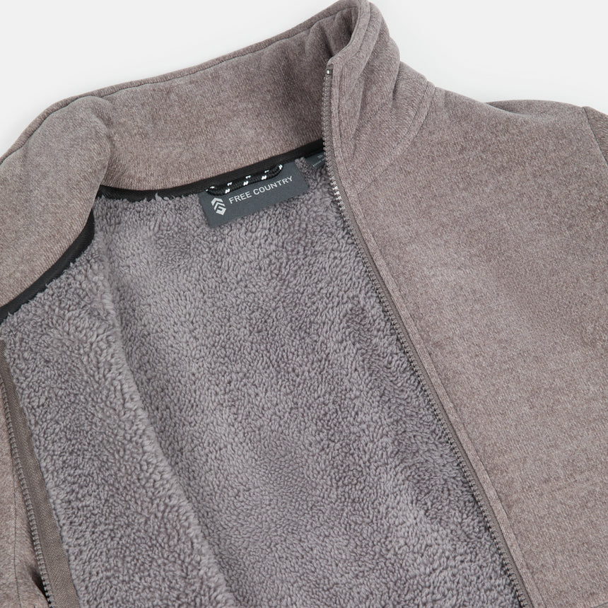Close-up of a taupe fleece jacket pile lining with a brand label on a white background