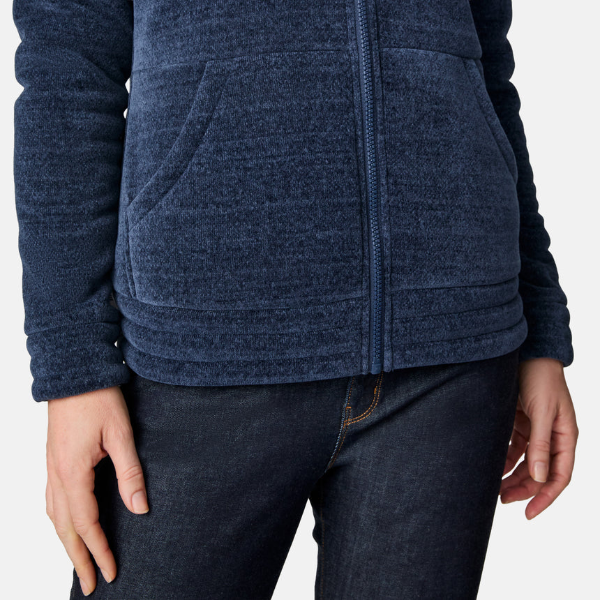 [CJ is 5'10" wearing size S.] Women’s dark blue zip-up fleece jacket with high collar, soft textured fabric, and dual front pockets—features a patch on the left sleeve and is styled with hands in pockets against a plain white background.