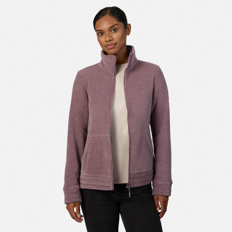 [Model is wearing size S.] A woman modeling a dusty mauve zip-up fleece jacket, paired with black pants and tan boots, against a plain light gray studio background.