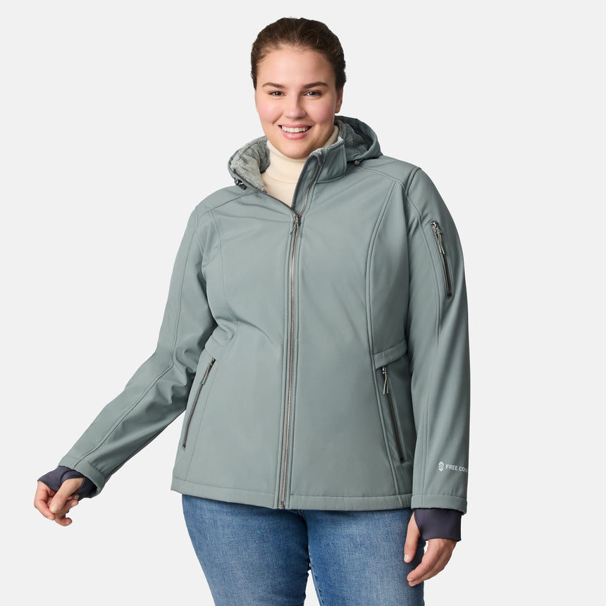 [Karissa is 5'9.5" wearing size 1X.] Light green hooded softshell jacket with zippered pockets on sides and sleeve; styled over blue jeans.