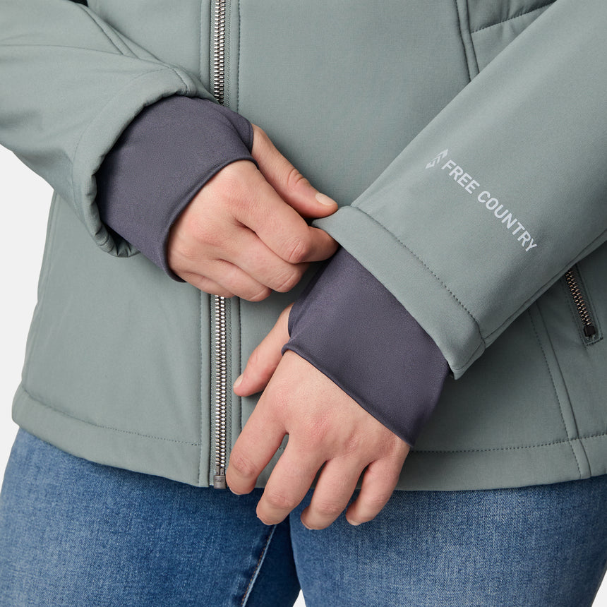 [Karissa is 5'9.5" wearing size 1X.] Light green hooded softshell jacket with zippered pockets on sides and sleeve; styled over blue jeans.