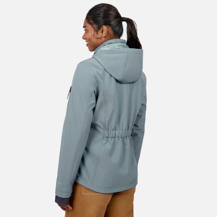 [Model is wearing size S.] A woman shown from the back wearing a slate blue hooded jacket with a drawstring waist, paired with brown pants, against a light gray studio background.