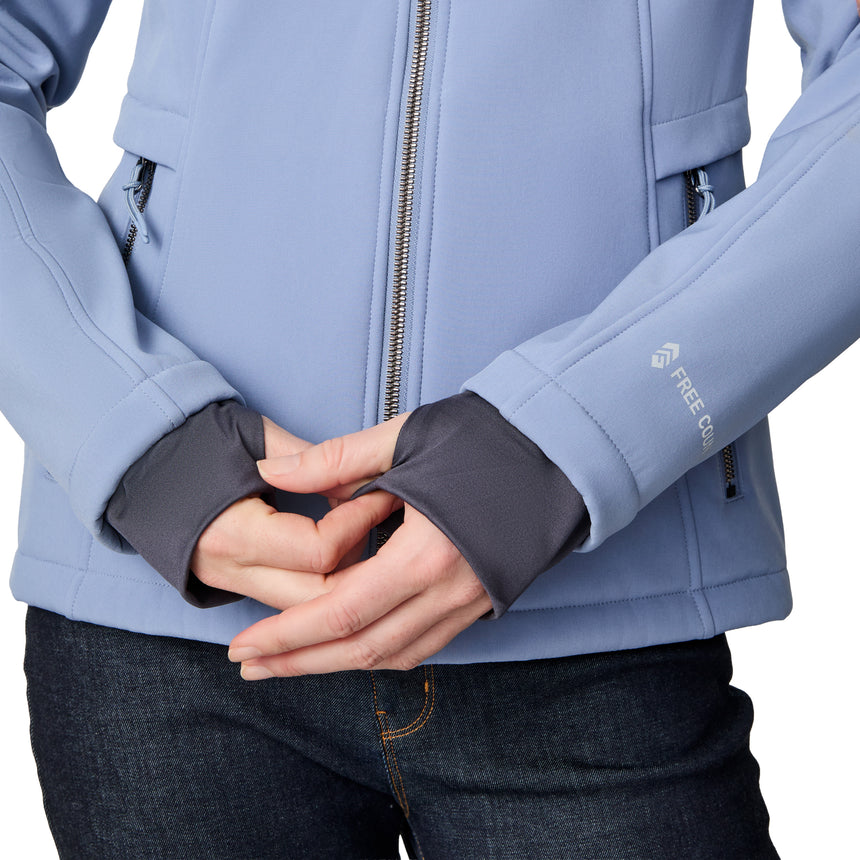 [CJ is 5'10" wearing size S.] Woman wearing a blue Free Country softshell jacket with a hood on a white background