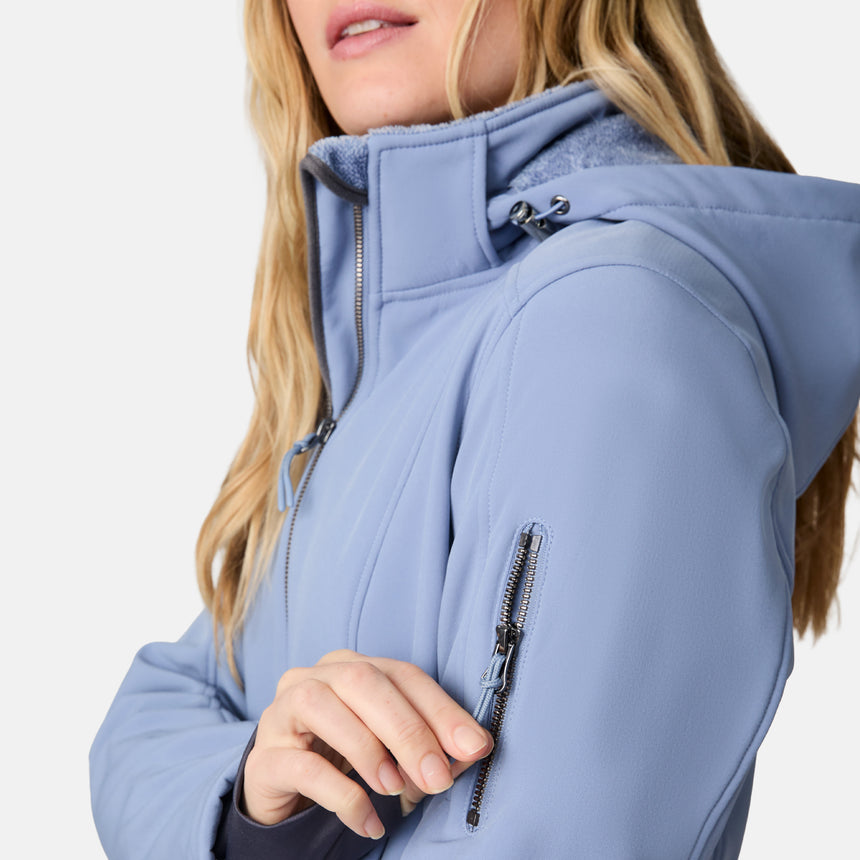 [CJ is 5'10" wearing size S.] Woman wearing a blue Free Country softshell jacket with a hood on a white background