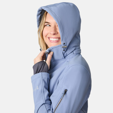 [CJ is 5'10" wearing size S.] Woman wearing a blue Free Country softshell jacket with a hood on a white background