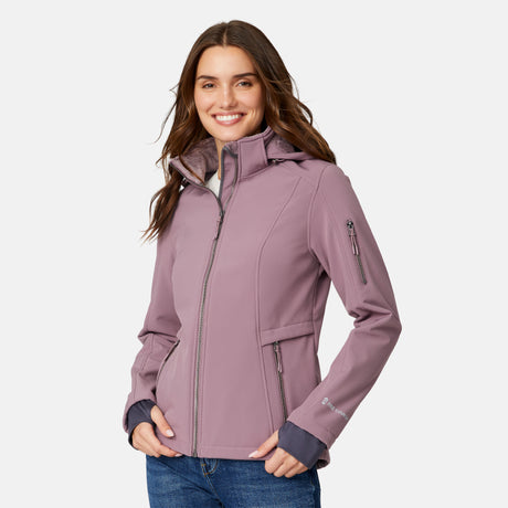 [Jessica is 5'9.5" wearing size S.] Woman wearing a purple Free Country softshell jacket with a hood on a white background
