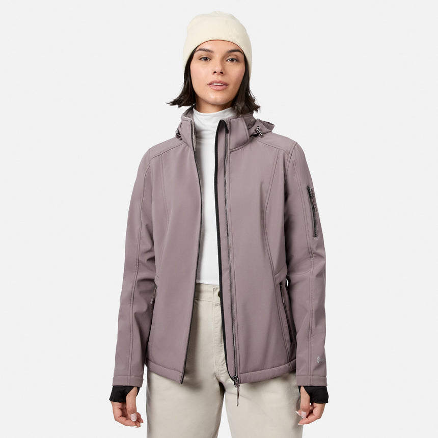 [Model is wearing size S.] A woman wearing a light dusty purple hooded jacket over a white turtleneck, paired with light beige pants and a cream beanie, standing against a solid light gray background.