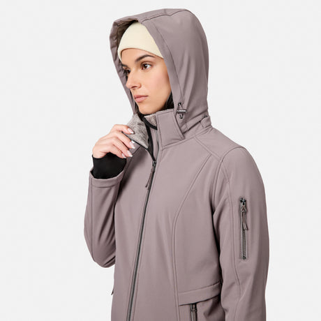 [Model is wearing size S.] A woman wearing a muted taupe-gray hooded jacket with a high collar, zippered front, and zippered sleeve pocket, shown against a light gray studio background.