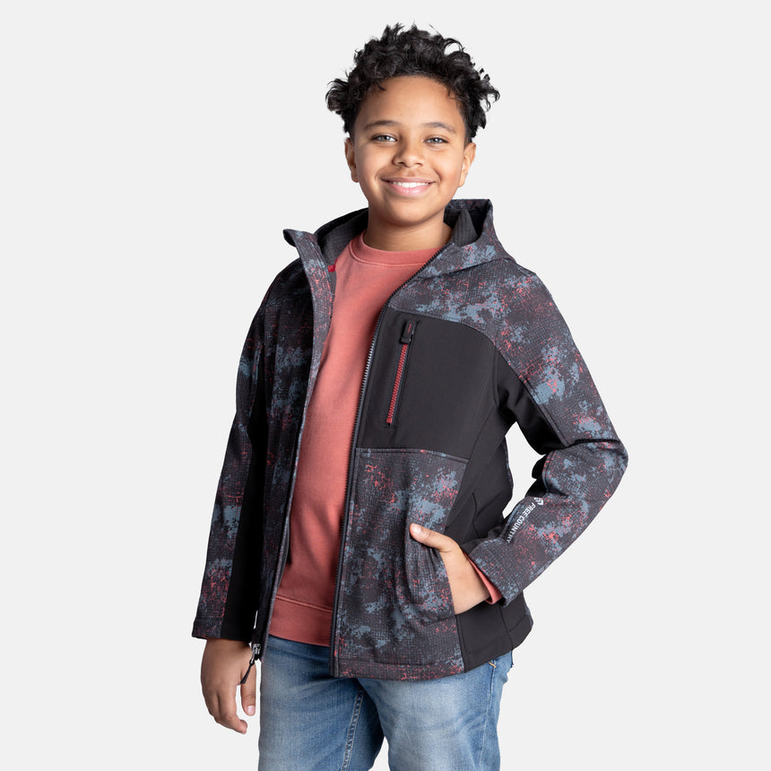 [Model is wearing size M.] Model wearing a red, black, and gray digital camo Free Country jacket featuring contrast side panels, zippered chest pocket, and full front zip; styled with denim for a bold, performance-ready outdoor look.