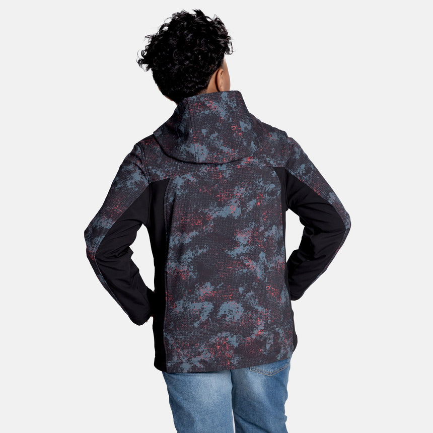 [Model is wearing size M.] Model wearing a red, black, and gray digital camo Free Country jacket featuring contrast side panels, zippered chest pocket, and full front zip; styled with denim for a bold, performance-ready outdoor look.