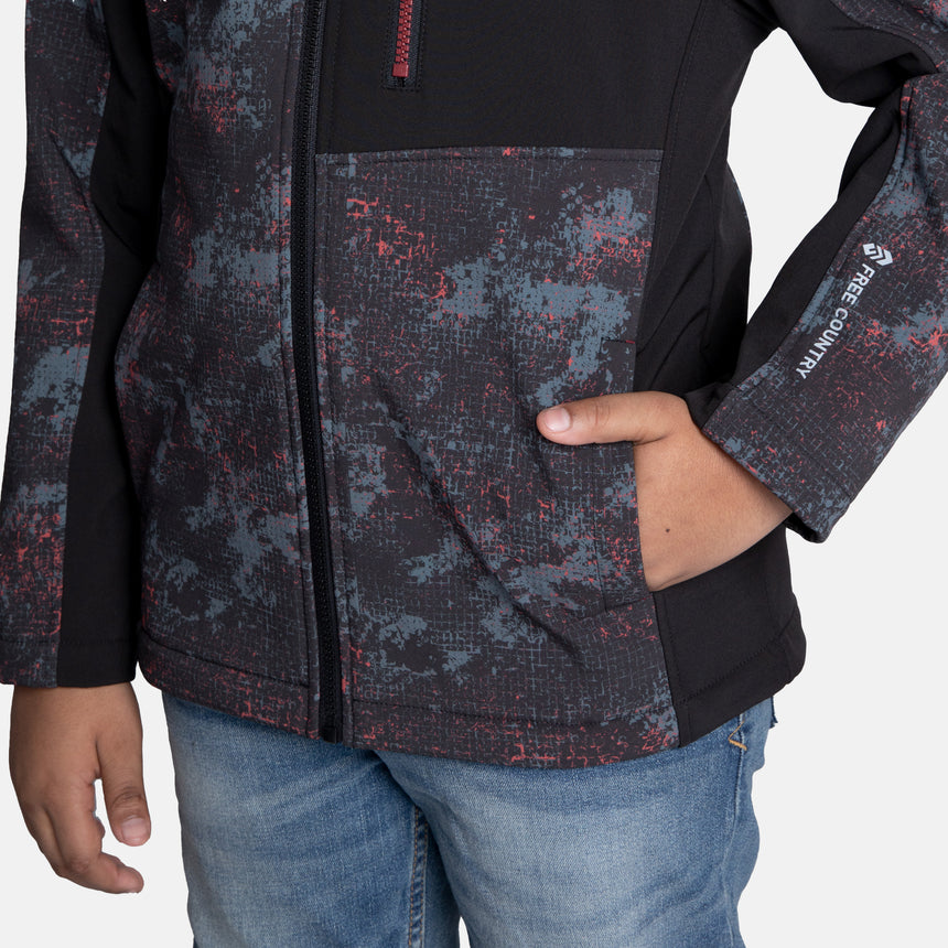 [Model is wearing size M.] Model wearing a red, black, and gray digital camo Free Country jacket featuring contrast side panels, zippered chest pocket, and full front zip; styled with denim for a bold, performance-ready outdoor look.