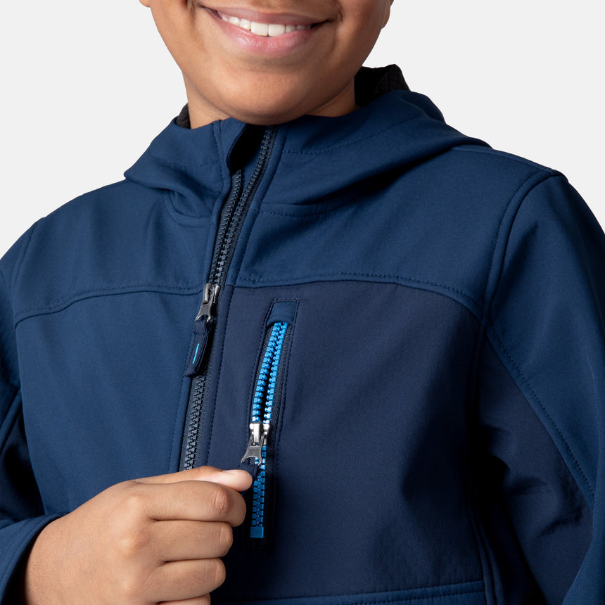 [Model is wearing size M.] Model wearing a blue Free Country softshell jacket with a contrast zippered chest pocket and side-entry hand pockets; lightweight water-resistant construction with an active fit, ideal for transitional weather and casual outdoor wear.