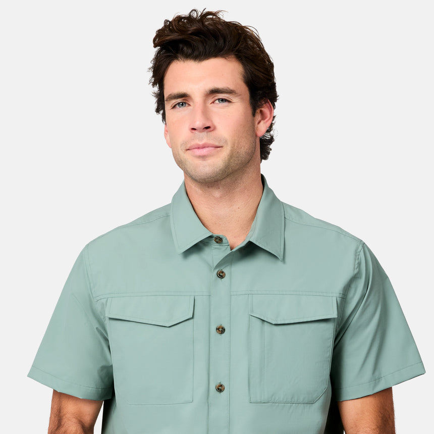 [Jacob is 6’1.5” wearing size M] Man wearing a light green short-sleeve shirt on a white background