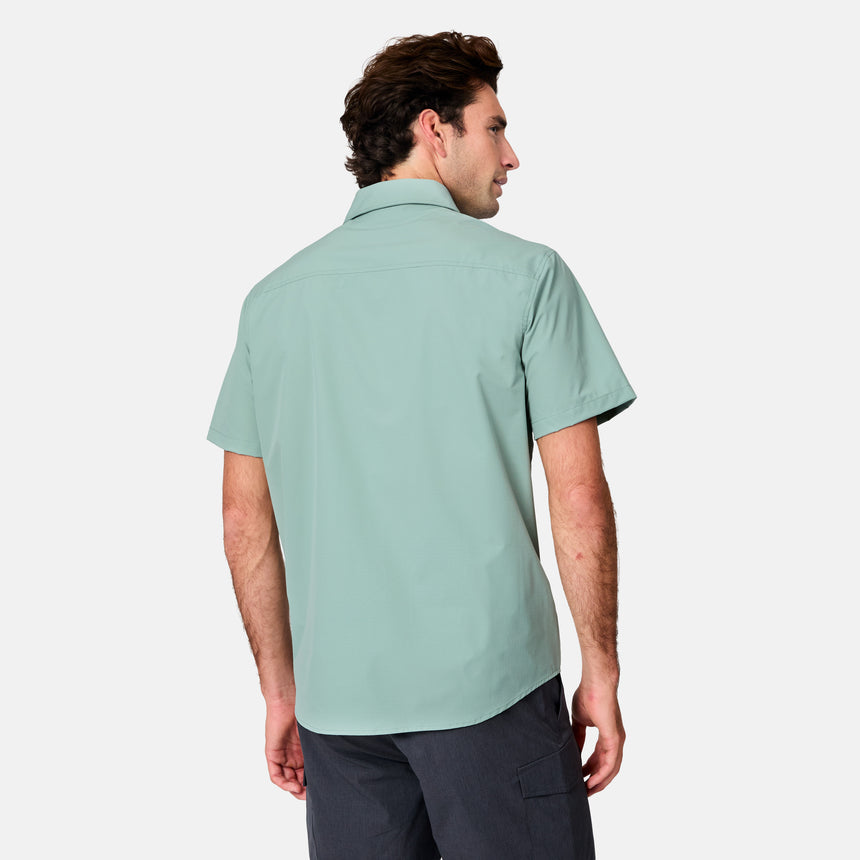 [Jacob is 6’1.5” wearing size M] Man wearing a light green short-sleeve shirt on a white background
