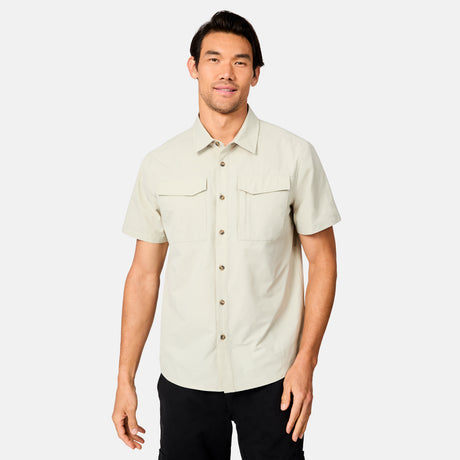 [Scott is 6’3 wearing size M] Man wearing a tan short-sleeve button up shirt on a white background