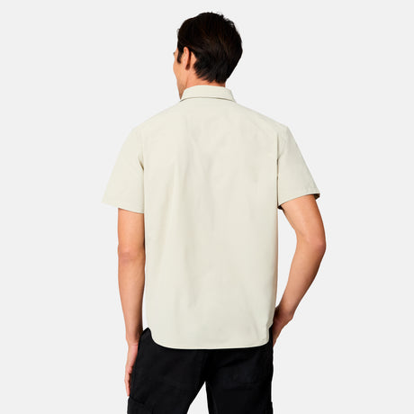 [Scott is 6’3 wearing size M] Man wearing a tan short-sleeve button up shirt on a white background