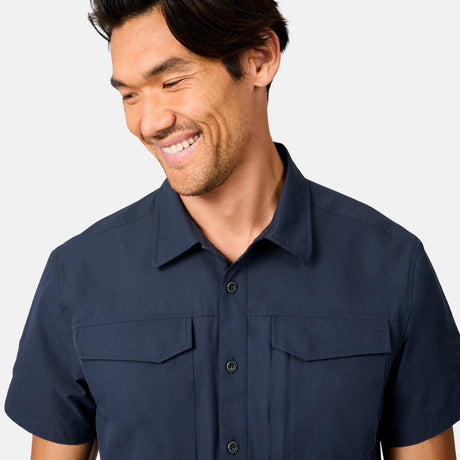 [Scott is 6’3 wearing size M] Man wearing a navy blue short-sleeve button up shirt on a white background