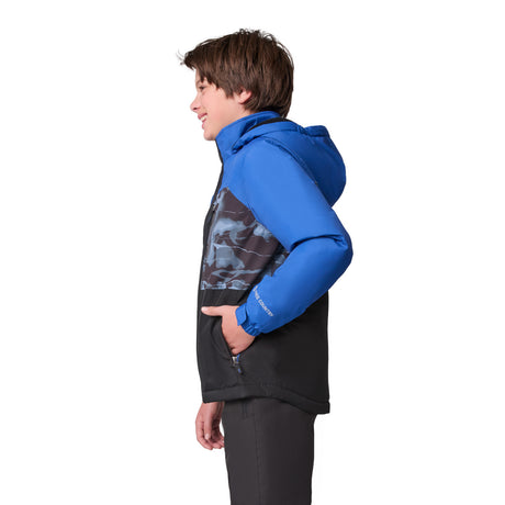 A boy wearing the Free Country Boys' Out of Bound Boarder Jacket stands in profile, facing left with his hands in his pockets, set against a white background.