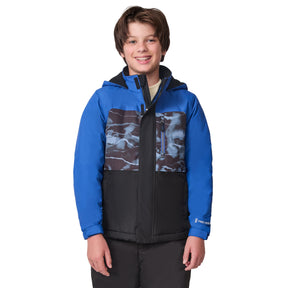 A smiling boy wears the Free Country Boys' Out of Bound Boarder Jacket—a stylish blue, black, and gray camo hooded winter coat that keeps him warm against a white background.