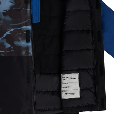 Close-up of the Free Country Boys' Out of Bound Boarder Jacket, showing quilted black lining, a patterned inner flap, and a white label saying "Hello explorer, it’s your jacket now!"—perfect winter outerwear for any adventure.