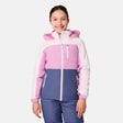 [Samantha is wearing size M.] Model wearing a Free Country color-blocked winter jacket in pink and navy, featuring a fuzzy-lined hood, zippered chest and hand pockets, and insulated design for cold-weather comfort. Paired with matching navy snow pants for outdoor adventures.