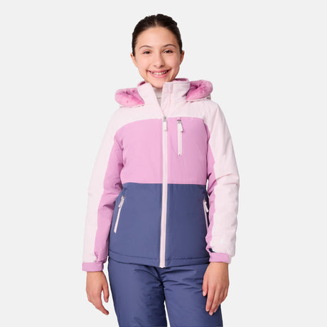 [Samantha is wearing size M.] Model wearing a Free Country color-blocked winter jacket in pink and navy, featuring a fuzzy-lined hood, zippered chest and hand pockets, and insulated design for cold-weather comfort. Paired with matching navy snow pants for outdoor adventures.